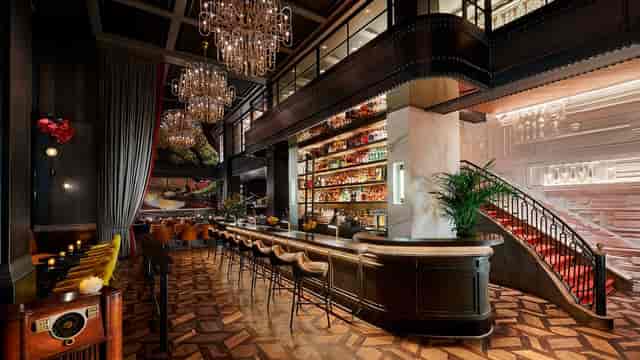 Sophisticated events venue with elegant bar and chandeliers for upscale gatherings.