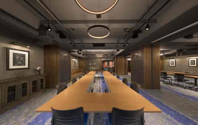 Modern conference room in The Helm with a long wooden table for professional events.
