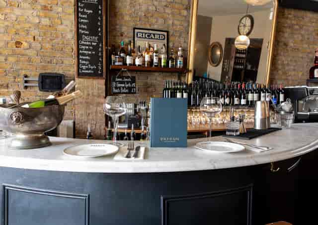 Stylish bar at Patron Restaurant, featuring marble countertop for networking events.