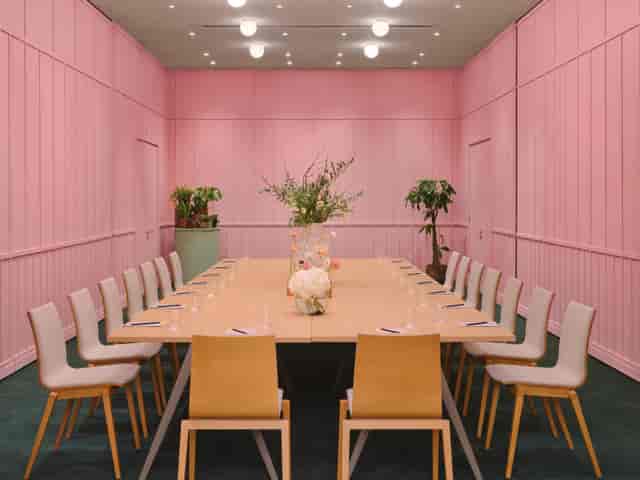 Stylish meeting room with pink backdrop, ideal for creative sessions at art'otel London.