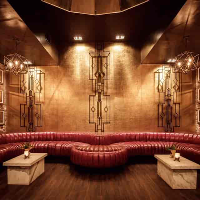 Intimate dance floor in Shimmytown with red leather seating for networking events.