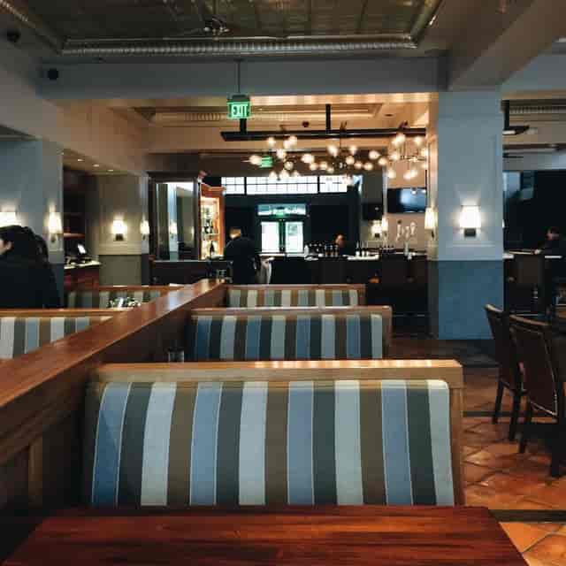 Rooftop Bar in BellaVista: modern venue with cozy booth seating for networking events.