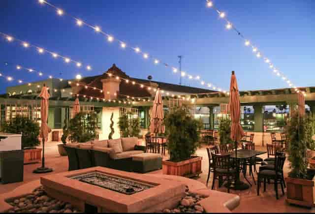 Rooftop Bar in BellaVista with string lights, ideal for receptions and networking events.
