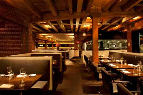 Stylish restaurant interior with brick walls, perfect for private dining events.