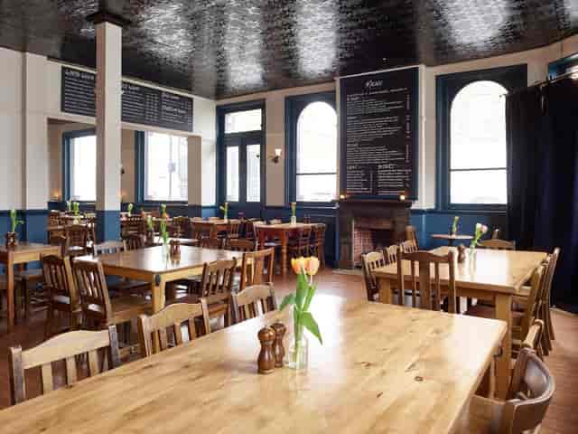Spacious Lansdowne Pub venue with wooden tables, ideal for meetings and events.