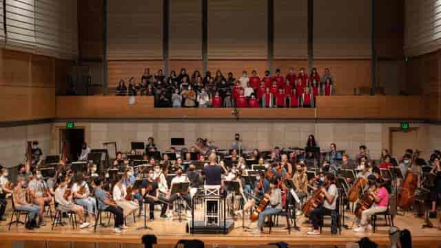 Ensemble-in-Residence rehearsing in a concert hall for music events and performances.