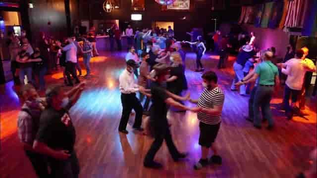Lively dance floor in Sundance Saloon for social dance event and networking.