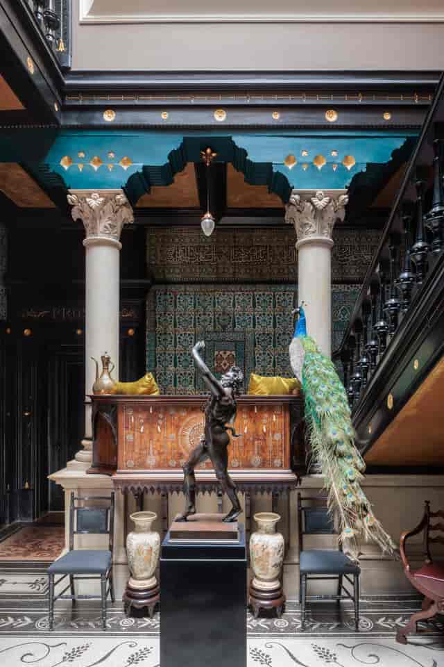 Christmas party venue at Leighton House with elegant columns and artistic decor.