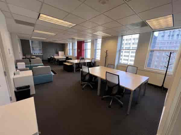 Versatile conference room with natural light, ideal for workshops and meetings.
