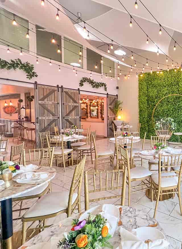 Violet Cactus Venue with elegant tables, gold chairs for events and gatherings.