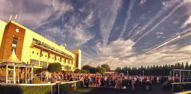 Single Box at Kempton Park Racecourse, vibrant outdoor festival with large crowd.