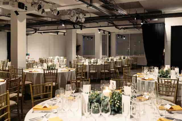 Elegant event space with round tables, perfect for weddings and corporate gatherings.