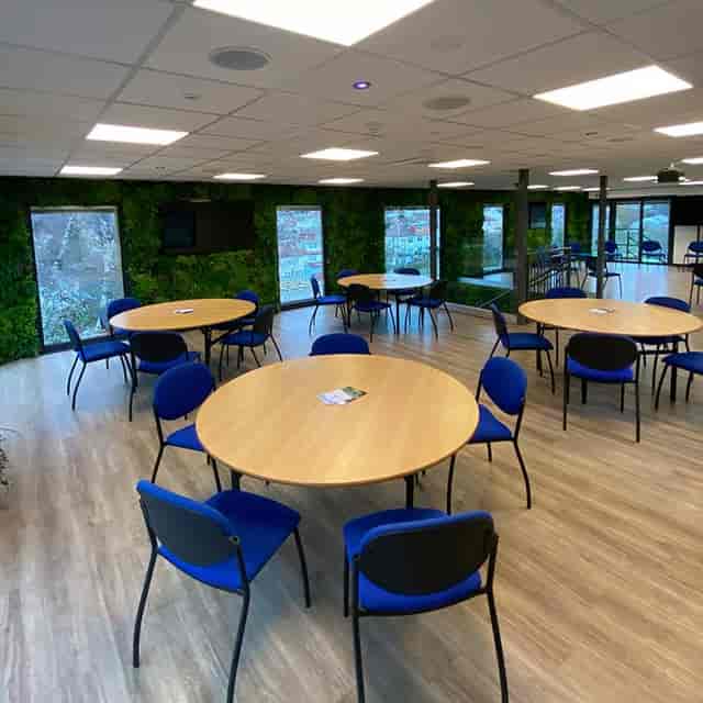 Small meeting room in The Manor Leeds with round tables, ideal for workshops and networking.