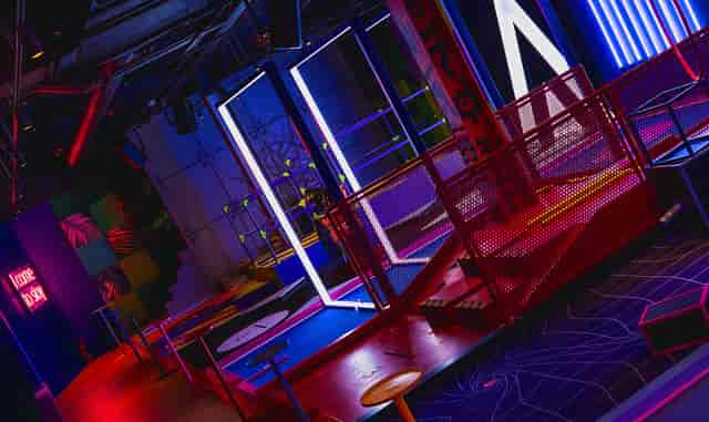 Vibrant B-Side event space with colorful lighting for team-building and social gatherings.