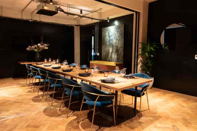 Stylish meeting room with wooden table, ideal for intimate gatherings and events.