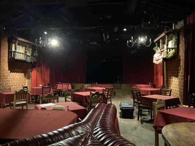 Cozy event space at El Cid Sunset with red tablecloths, perfect for dinners and performances.
