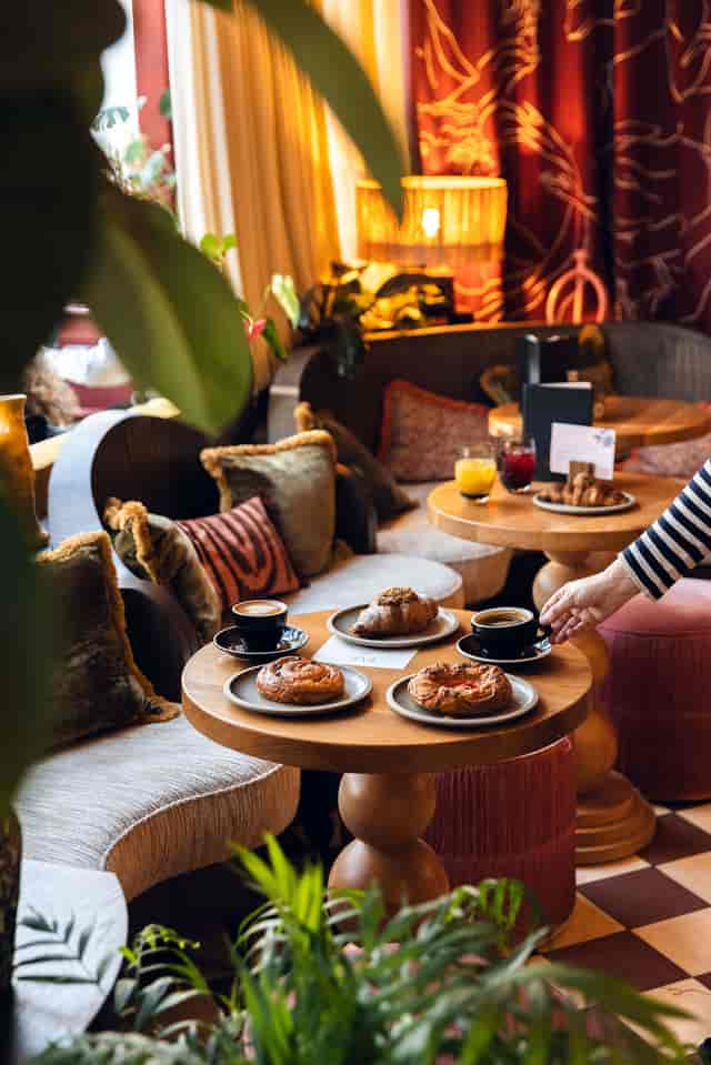 Cozy Jungle Booth bar area with pastries, ideal for casual networking events.