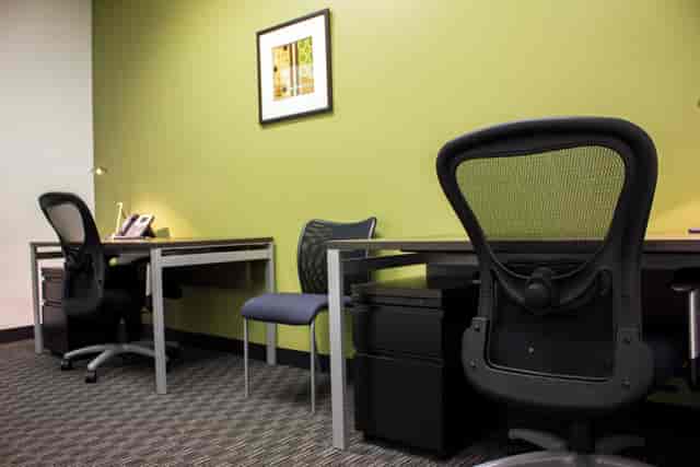 Modern minimalist workspace with ergonomic chairs for collaborative meetings.