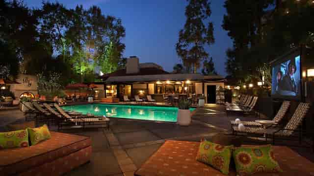 Outdoor event venue at The Garland with serene pool and cozy seating for gatherings.