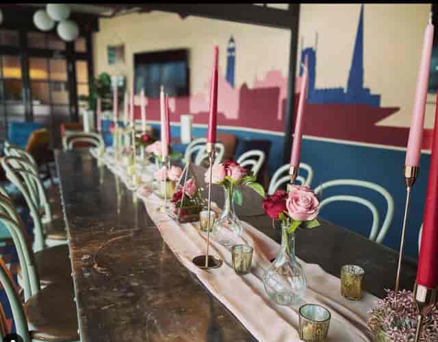 Elegant long table with pink candles for intimate gatherings at The Furnace.