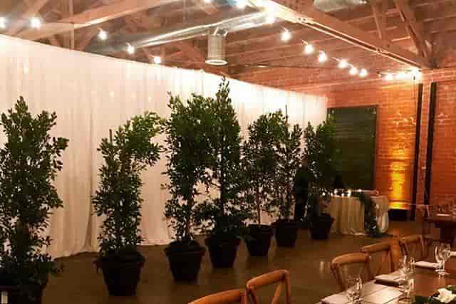 Elegant outdoor patio with white drapery, ideal for intimate gatherings and upscale dinners.