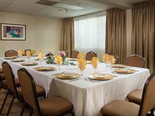 Elegant banquet table with yellow napkins at Coast Anabelle Hotel for intimate events.