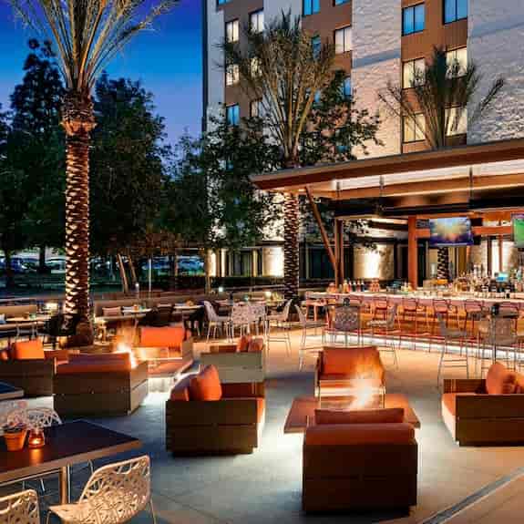 Stylish outdoor Media Lounge at Los Angeles Marriott for events with cozy fire pits.