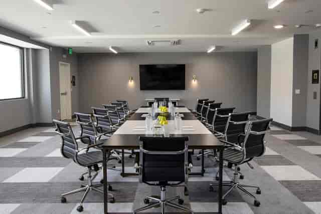 Modern meeting room at Olia Restaurant, featuring ergonomic chairs for corporate events.