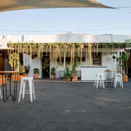 Stylish outdoor patio venue with greenery for events and gatherings at The One Event Hall.
