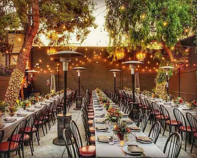 Outdoor patio dining space with floral centerpieces, ideal for weddings and corporate events.