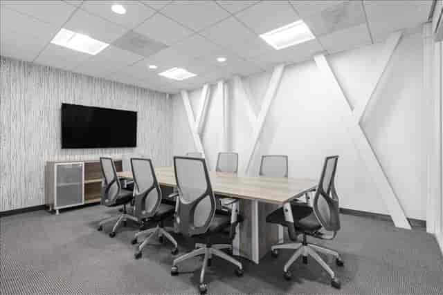 Modern meeting room with large table and ergonomic chairs at Brand Boulevard Executive Center.