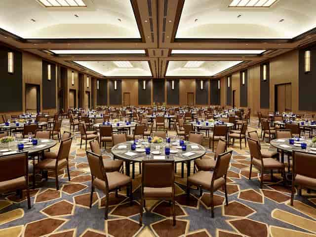 Tiered classroom at UCLA Luskin Center, set for elegant corporate event with blue decor.