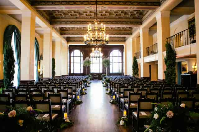 Elegant Lounge & Art Salon wedding venue with chandeliers and floral decor.