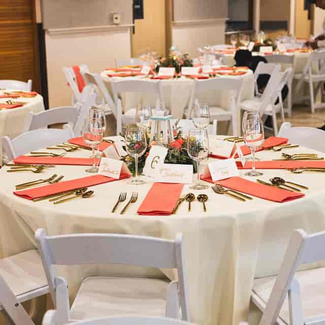 Elegant banquet table with coral napkins at CMG Cultural Center for weddings and events.