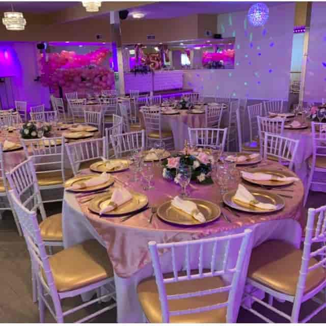 Elegant banquet hall with pink linens, perfect for weddings and upscale events.