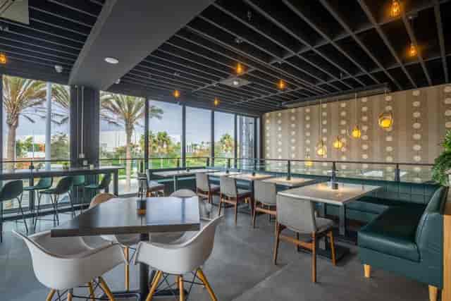 Modern event space in Cork & Batter with natural light and stylish seating for networking.