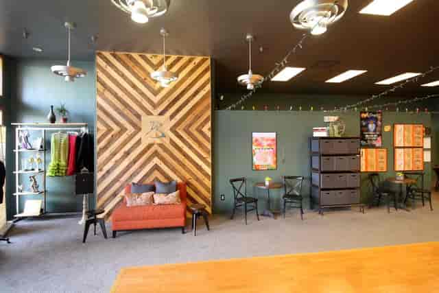 Practice Parties at Arthur Murray Dance Studio with stylish wooden wall and flexible seating.