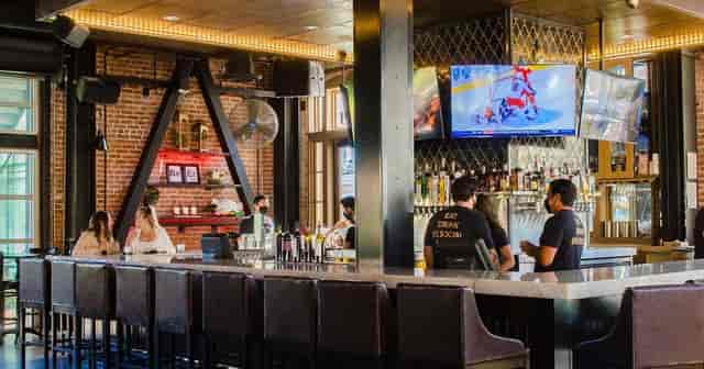 Vibrant bar in Suite #101 at Social Tap Eatery for casual networking events.