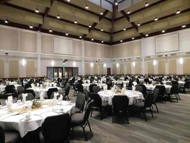 Spacious Liberty Station Conference Center with elegant round tables for formal events.