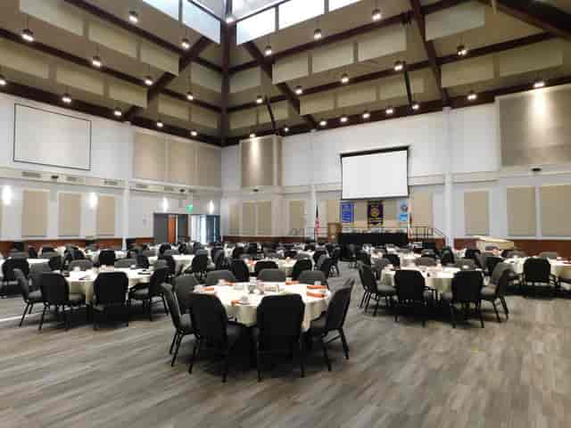 Spacious Liberty Station Conference Center with round tables for corporate events.