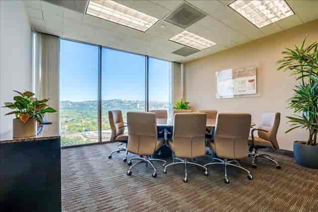 Modern conference room with oval table, ideal for corporate meetings and strategic planning.