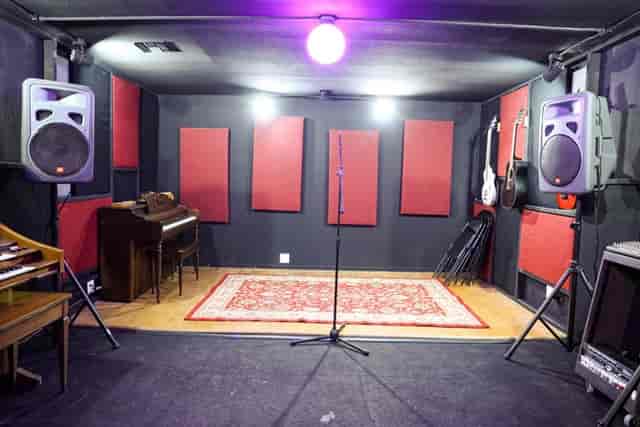 Custom recording booth with acoustic panels for music events and presentations.
