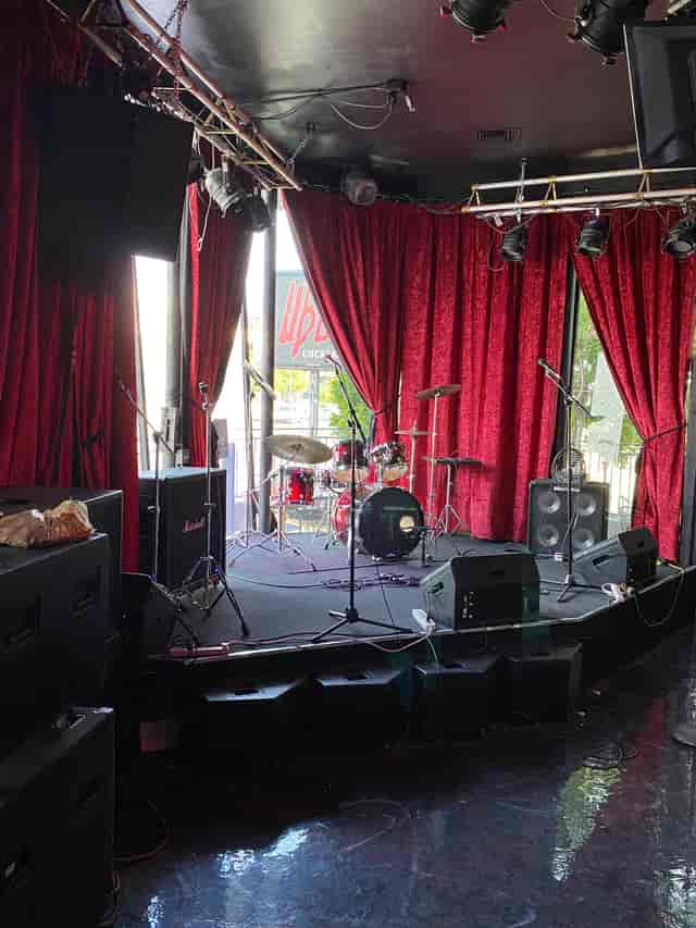 Bar Area at Universal Bar & Grill with stage setup for live performances and concerts.