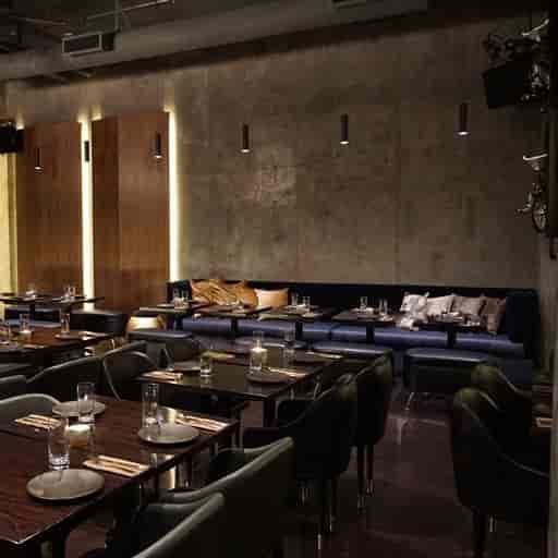 Modern dining room with dark wood tables, perfect for intimate gatherings and corporate dinners.