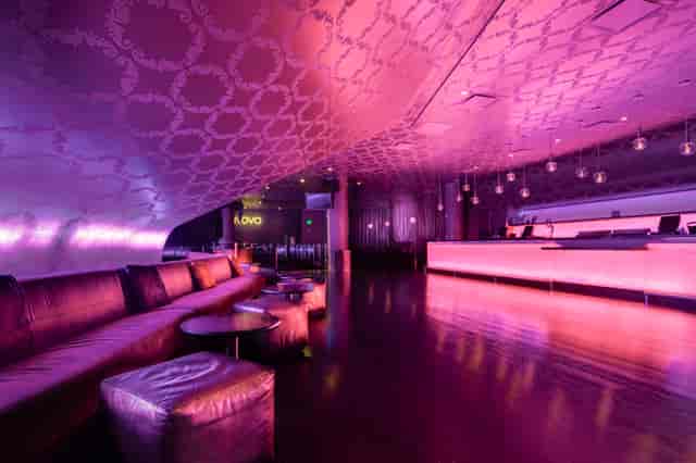 Sleek modern venue with purple ambiance, ideal for upscale cocktail receptions.