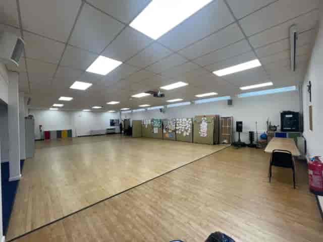 Spacious event room with wooden flooring at Hope Corner Community Centre for workshops and meetings.
