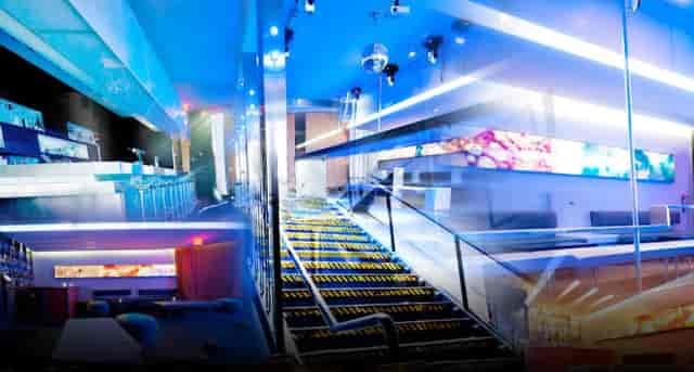DJ booth in Onyx Room Nightclub with vibrant lighting for corporate events and social gatherings.