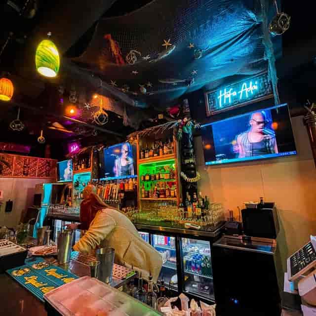 Vibrant Manhattan bar with colorful lighting, ideal for lively events and gatherings.