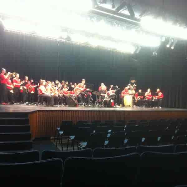 Vibrant musical ensemble in red at Smith Recital Hall, San Diego State University event.