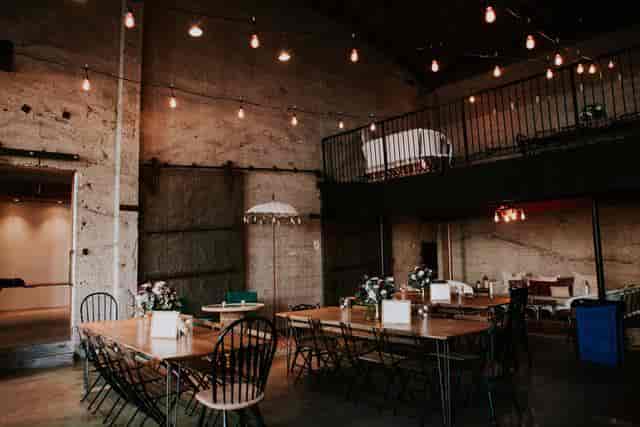 Showers in Luce Loft: industrial-chic event space with floral centerpieces.